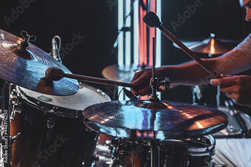 Photography A male drummer plays drums with special drum sticks.
