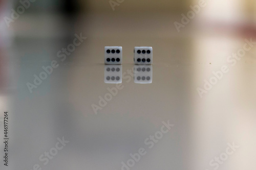 Pair of dice reflectiion showing two sixes the highest gambling gaming roll for betting and game concepts. (Selective focus) photo