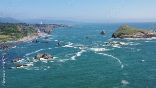 The Pacific Ocean washes against the scenic yet rugged and rocky coastline in southern Oregon. This beautiful region of the Pacific Northwest is accessible via highway 101. photo