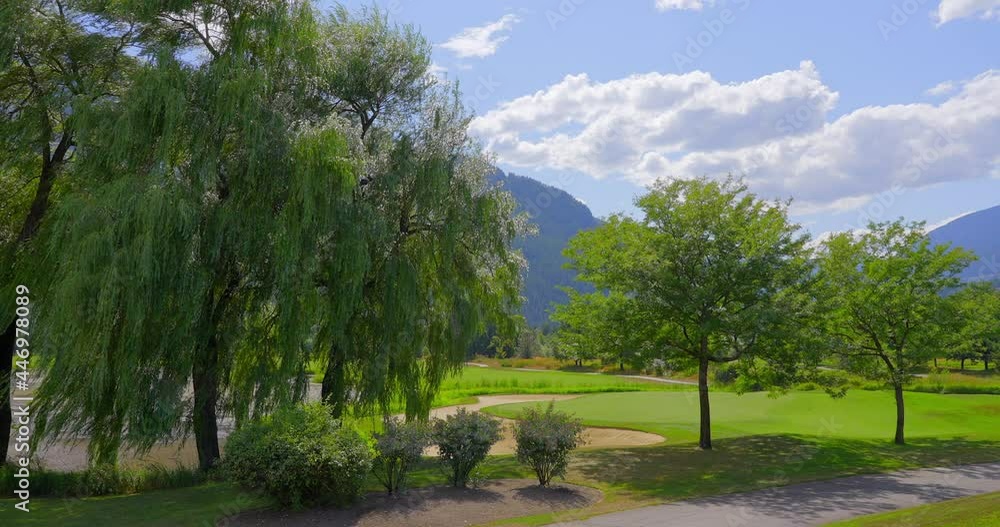 Establishing shot of golf course with gorgeous green and fantastic forest view in Vancouver, Canada, North America. Day time on July 2021. Still camera. ProRes 422 HQ. Establishing shot of golf course with gorgeous green and fantastic forest view in Vancouver, Canada, North America. Day time on July 2021. Still camera. ProRes 422 HQ.