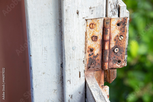 A rusted out butt hinge on the top half of a dutch door