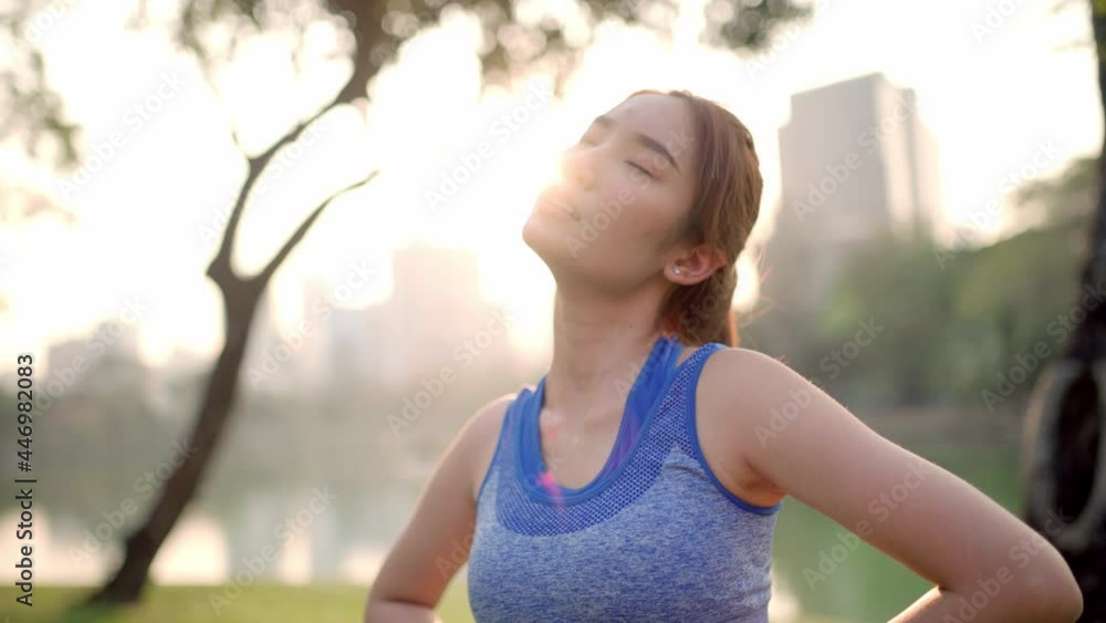 A woman is exercising beside a pond in the city park (stretching) A woman is exercising beside a pond in the city park (stretching)