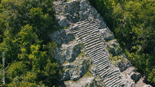 Aerial view of Ancient Mayan pyramid and Coba ruins in Mexico. Landscape panorama of Quintana Roo Peninsula from aboveL. Lush jungle on a sunny day, 4k UHD.