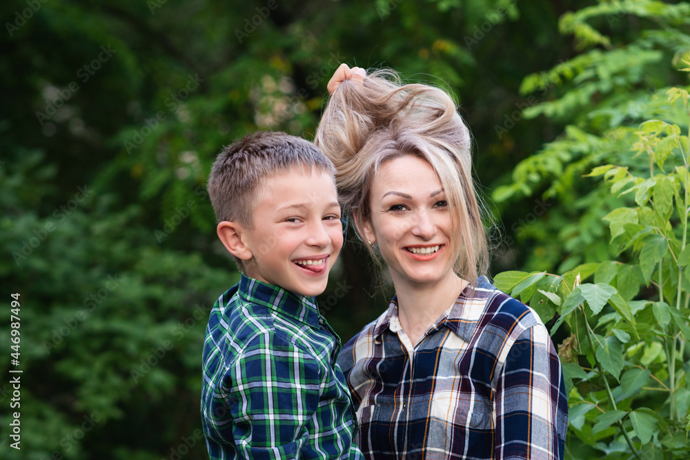 Playful outdoors. Wonderful Mom with son in backyard vacation. Joyful Family having fun. Playful outdoors. Wonderful Mom with son in backyard vacation. Joyful Family having fun.