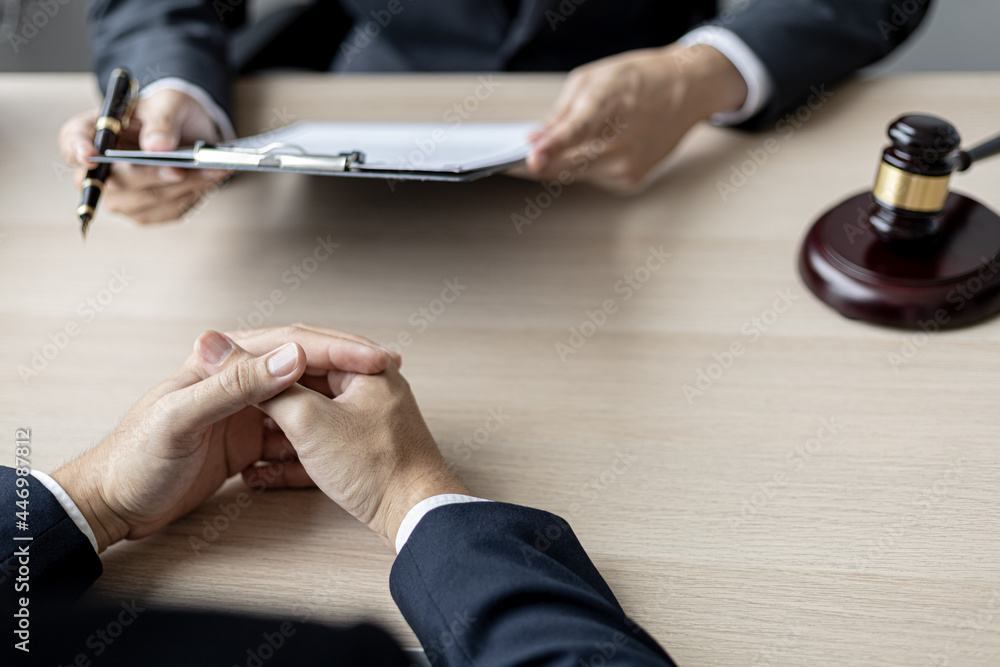 Fototapeta premium Client was listening to a lawyer advising on an embezzlement case, explaining the details of the proceeding and gathering evidence to file a lawsuit against the defendant. The concept of litigation.