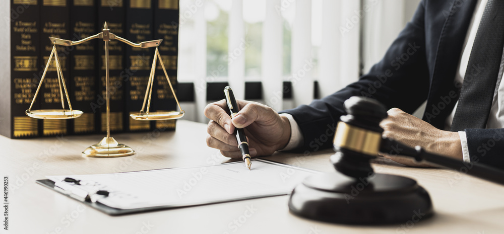 A male lawyer is signing a plea agreement with a client in a fraud case, in which the client has filed a lawsuit against an employee at a company that commits the fraud. Fraud litigation concept. - obrazy, fototapety, plakaty 