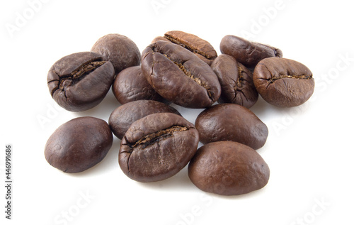 Roasted coffee beans close up isolated on white background.