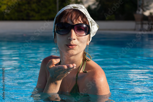 Young lovely woman posing in the pool © misu