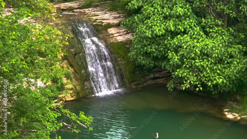 A picturesque waterfall with a lake in a mountain canyon. Landscape and nature of the North Caucasus
A picturesque waterfall with a lake in a mountain canyon. Landscape and nature of the North Caucasus