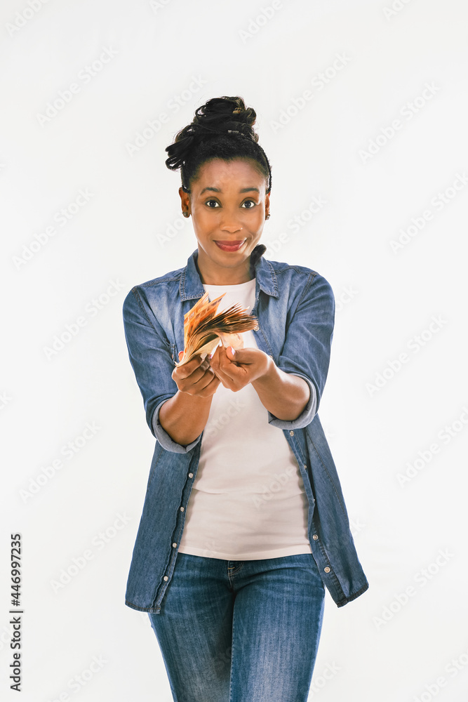 Smiling african woman showing a bunch of money bills at the camera Smiling african woman showing a bunch of money bills at the camera
