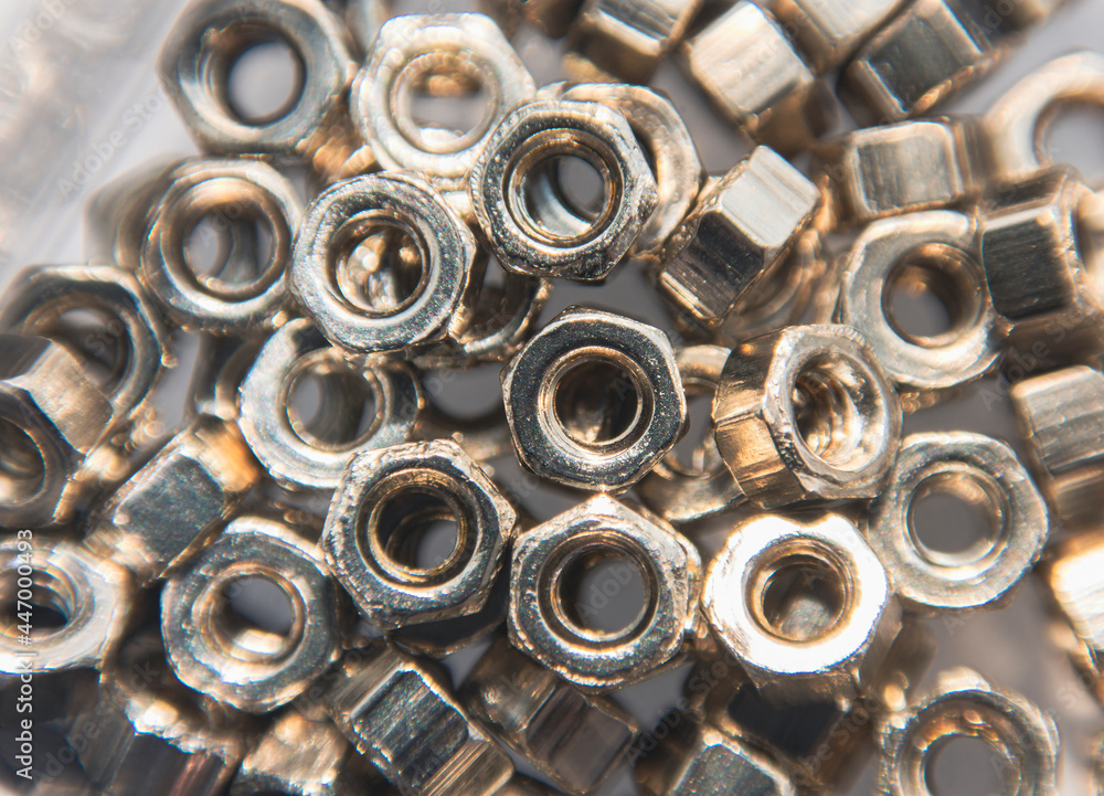 Metal nut pile on background,Close up macro with selective focus Metal nut pile on background,Close up macro with selective focus