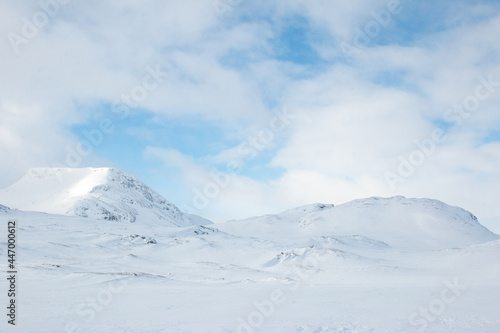 Mountains around Kungsleden trail close to Alesjaure hut covered in snow at sunrise in April 2021, Lapland, Sweden