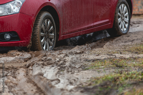Car stuck in the mud, car wheel in dirty puddle, rough terrain