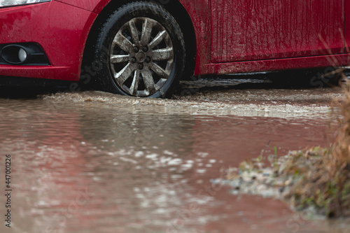 Car stuck in the mud, car wheel in dirty puddle, rough terrain