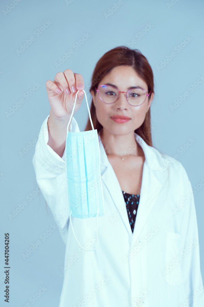 Health specialist showing the mask. Concept no mask needed. Sanitary people, doctor, biologist, pharmacist with blue gray background. Health specialist showing the mask. Concept no mask needed. Sanitary people, doctor, biologist, pharmacist with blue gray background.