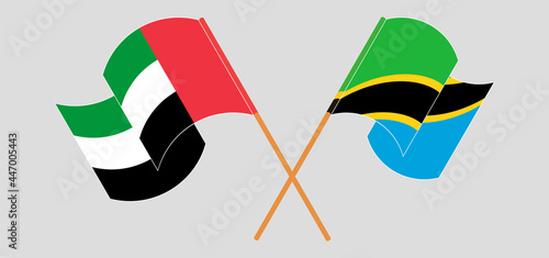 Crossed and waving flags of the United Arab Emirates and Tanzania