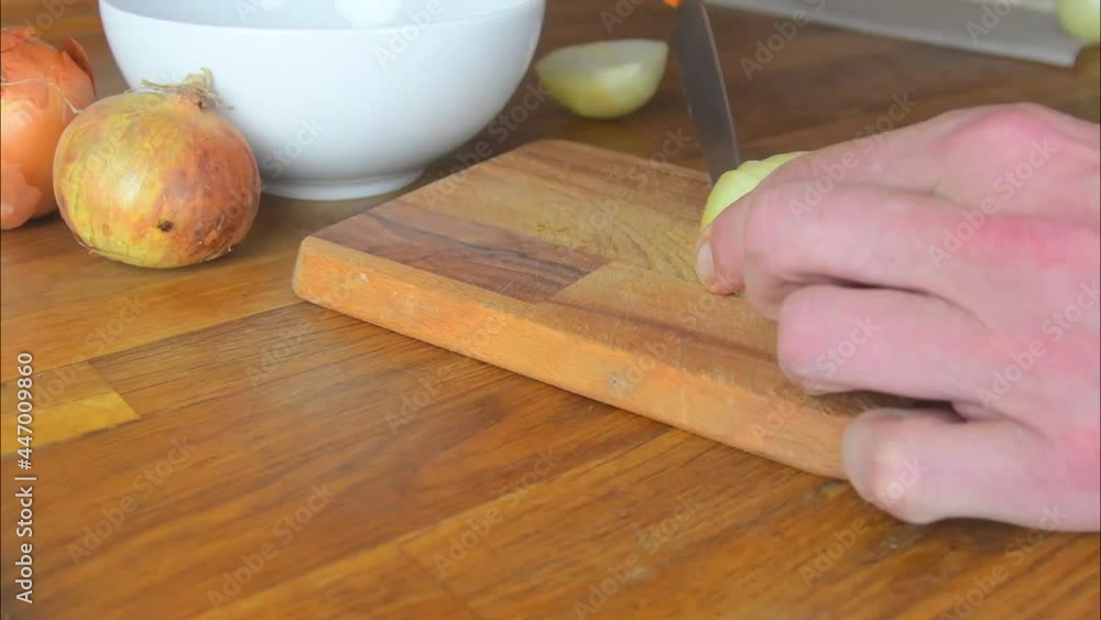 Male hands are cutting vegetables. Cooking in the kitchen. Close-up Male hands are cutting vegetables. Cooking in the kitchen. Close-up