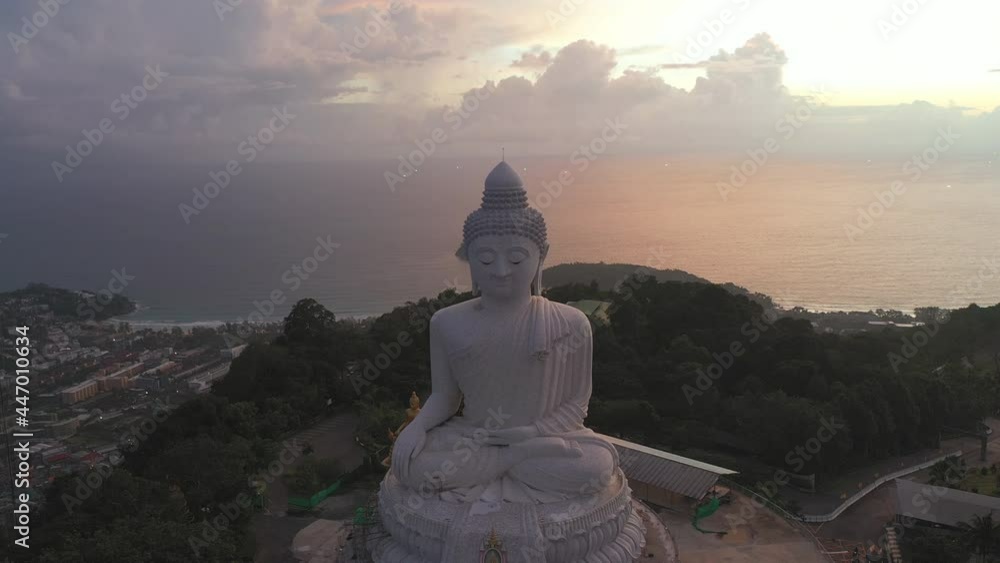 aerial view scenery sunset with rain clouds moving summer..beautiful silhouette Phuket big Buddha on hilltop..Another incentive to attract tourists to visit. 4k video for travel and worship concept aerial view scenery sunset with rain clouds moving summer..beautiful silhouette Phuket big Buddha on hilltop..Another incentive to attract tourists to visit. 4k video for travel and worship concept