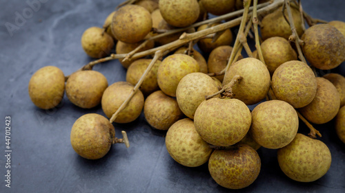 Fresh longan from the garden laid on the ground. Well-selected longan  Thai fruit. organic farming concept.