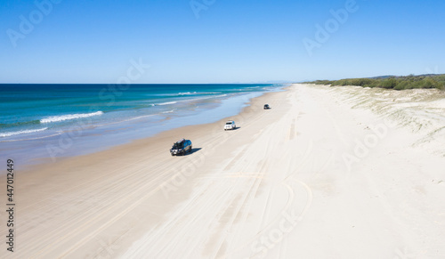 Holiday makers enjoying the beach. Tourists enjoy driving and stopping with their car, 4wd driving on infinite beach.