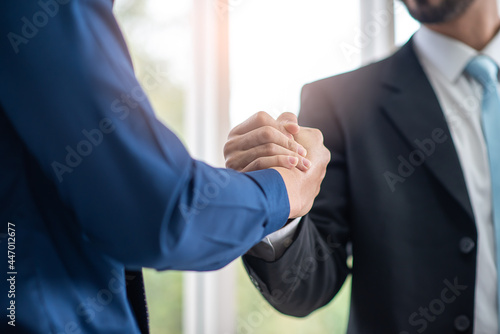 business people join hand together or hand shake agreed to as a partner and trust