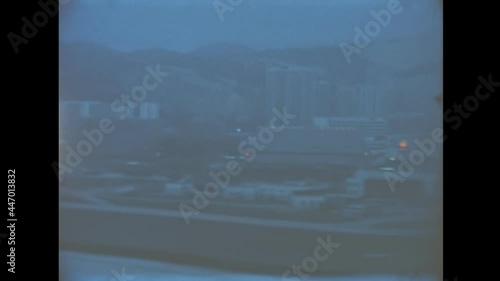 Chinese flight landing in Kai Tak airport , Hong Kong international airport of Victoria Harbour cityscape in 1987. Historic archival of Kai Tak, China airport, closed in 1998 for many urban incidents.