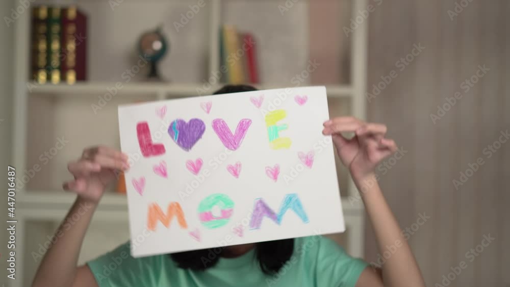 Little girl with drawing for mum, Happy kid preparing greeting card for mother Little girl with drawing for mum, Happy kid preparing greeting card for mother