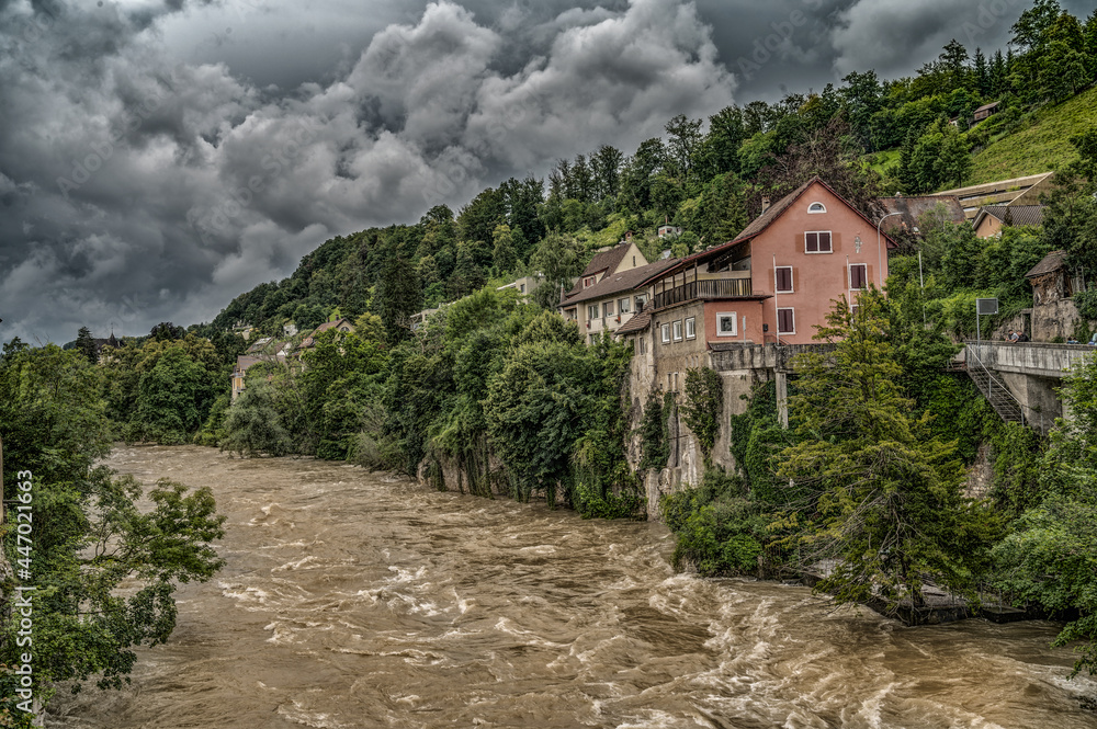 Fototapeta premium thunderstorn over a swiss landscape with a flooded river 