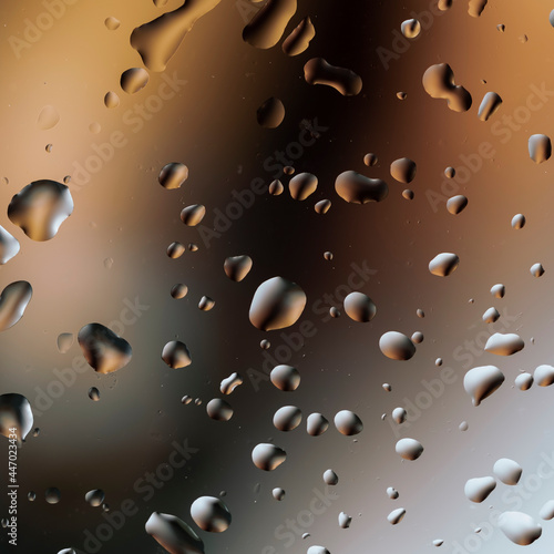 Abstract image of water droplets on glass surface reflecting with multicolored background.
