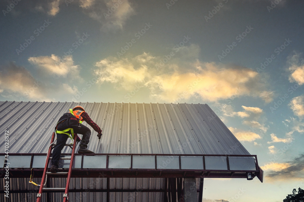 Worker man building tradesman on the roof of a house . with safety helmet, new home, construction concepts - Selective focus..vintage film grain filter effect styles