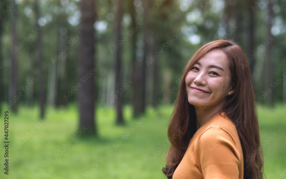 Portrait image of a beautiful young asian woman standing in the park Portrait image of a beautiful young asian woman standing in the park