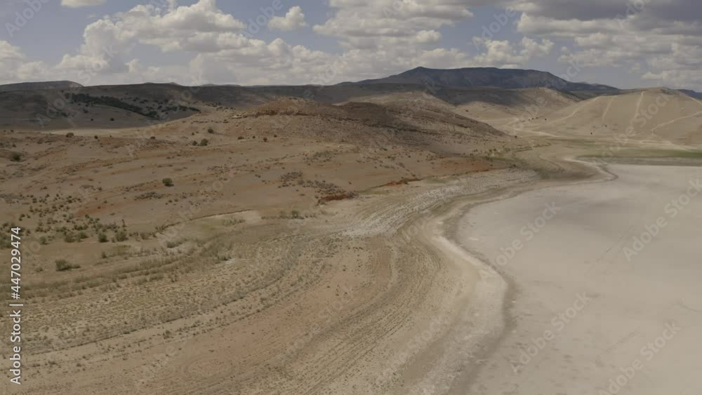 Aerial-Flying over shoreline of dry empty reservoir-Drained of all water because of need to continue to supply water during extended drought across much of the western United States Aerial-Flying over shoreline of dry empty reservoir-Drained of all water because of need to continue to supply water during extended drought across much of the western United States