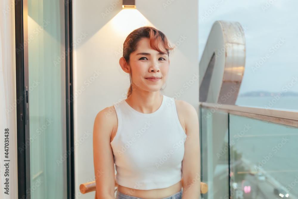 Beautiful Asian woman relax on hotel terrace with ocean view in summer. Beautiful Asian woman relax on hotel terrace with ocean view in summer.