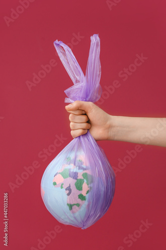 Woman holding garbage bag w...