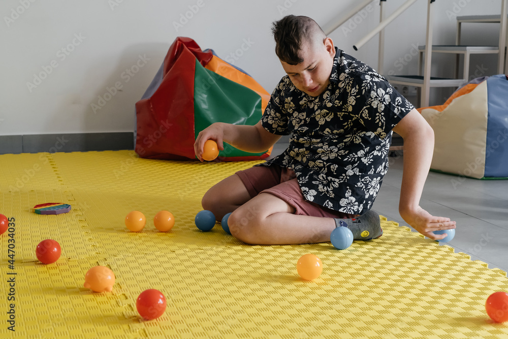 Children with disability getting sensory activity with toys, balls