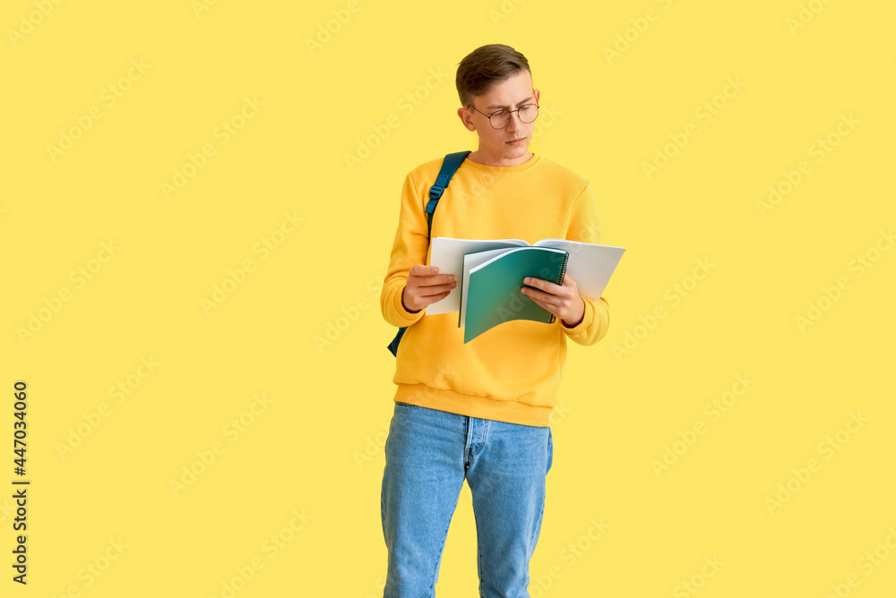 Male student with notebooks on color background Male student with notebooks on color background