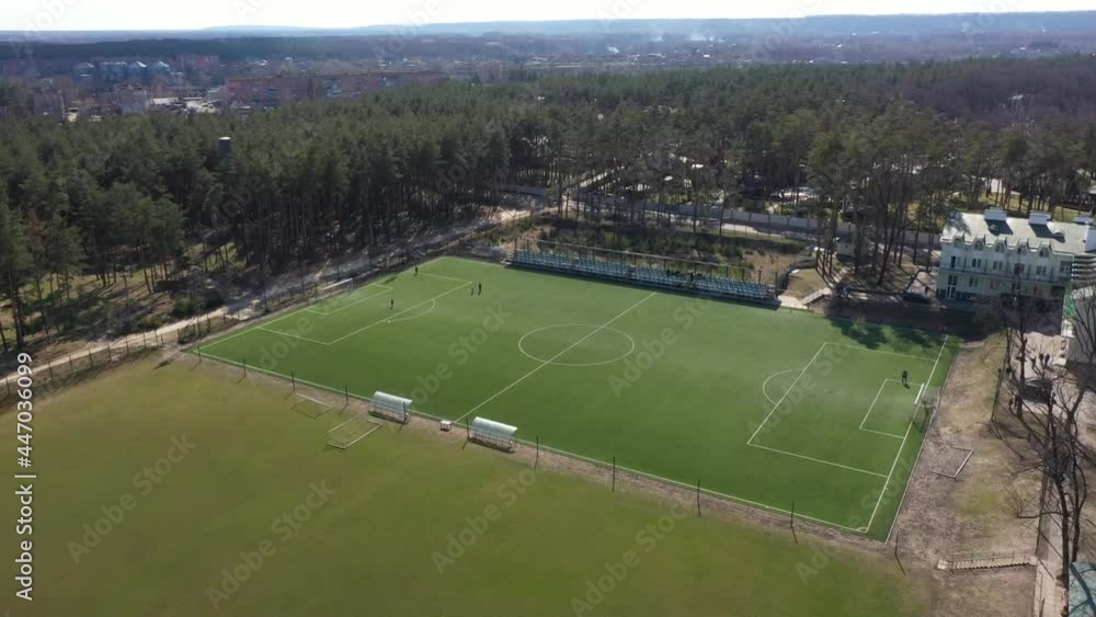 green soccer field with artificial turf in the forest aerial view green soccer field with artificial turf in the forest aerial view