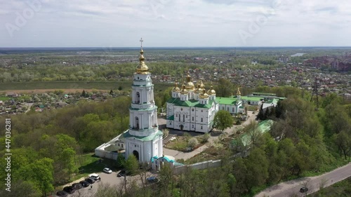 golden domes of the white monastery with crosses on the hill