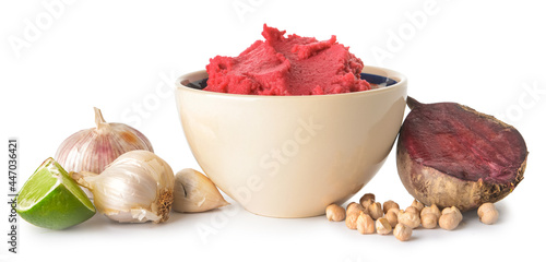 Bowl with tasty beet hummus, lime and garlic on white background