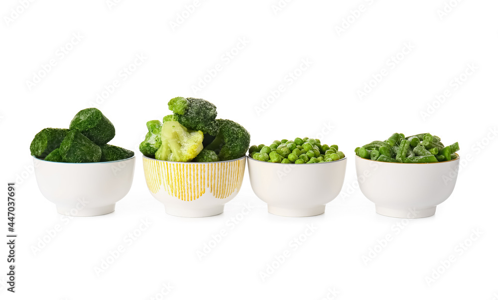 Bowls with frozen green vegetables on white background Bowls with frozen green vegetables on white background