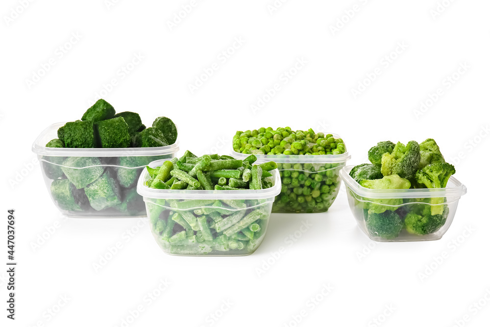 Containers with frozen green vegetables on white background Containers with frozen green vegetables on white background