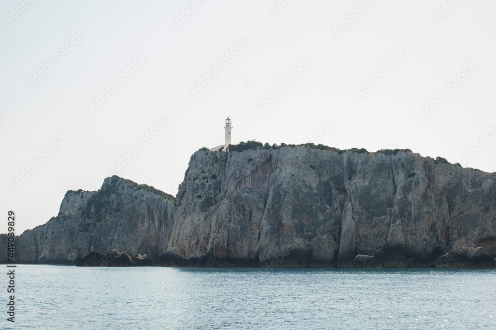 Boathouse, lighthouse on sea