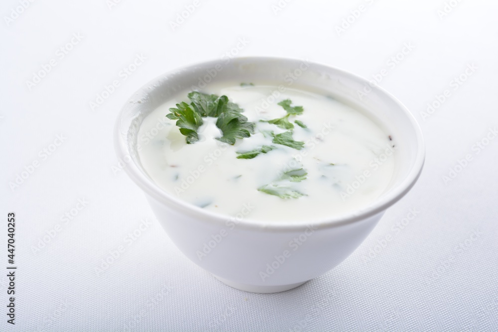Indian mint yogurt sauce in white background vegan snack Halal menu Indian mint yogurt sauce in white background vegan snack Halal menu