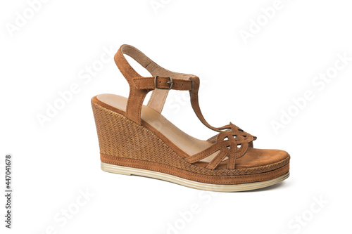 Suede women's sandal with a high flat heel isolated on a white background.