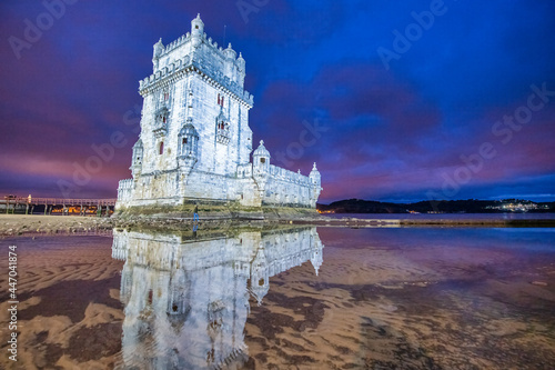 Belem Tower with tourists at night, Lisbon - Portugal.