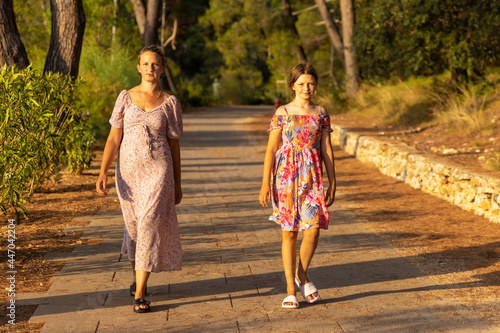 Mother and daughter are walking  on the path, Mali Losinj, Croatia