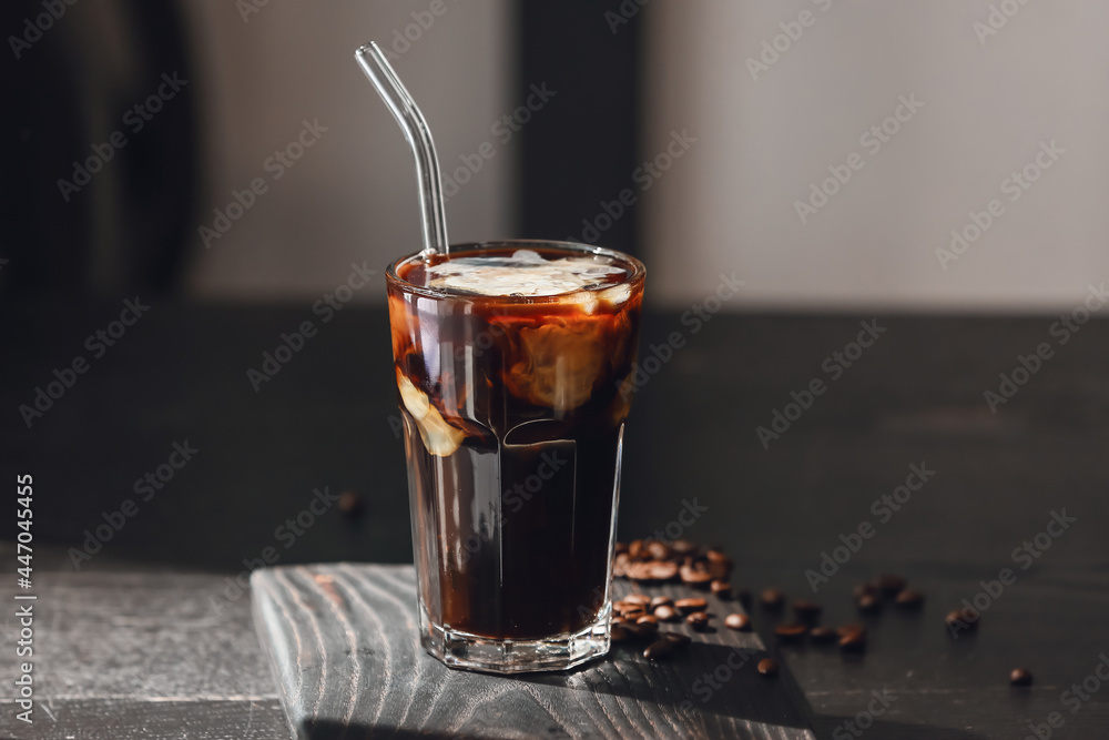 Glass of tasty iced coffee on dark wooden table Glass of tasty iced coffee on dark wooden table