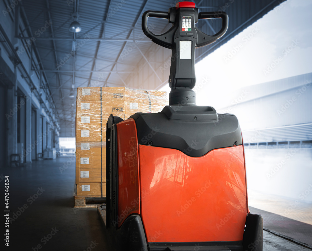 Electric Forklift Pallet Jack Loading Package Boxes at The Warehouse. Shipping Warehouse Logistics. Electric Forklift Pallet Jack Loading Package Boxes at The Warehouse. Shipping Warehouse Logistics.