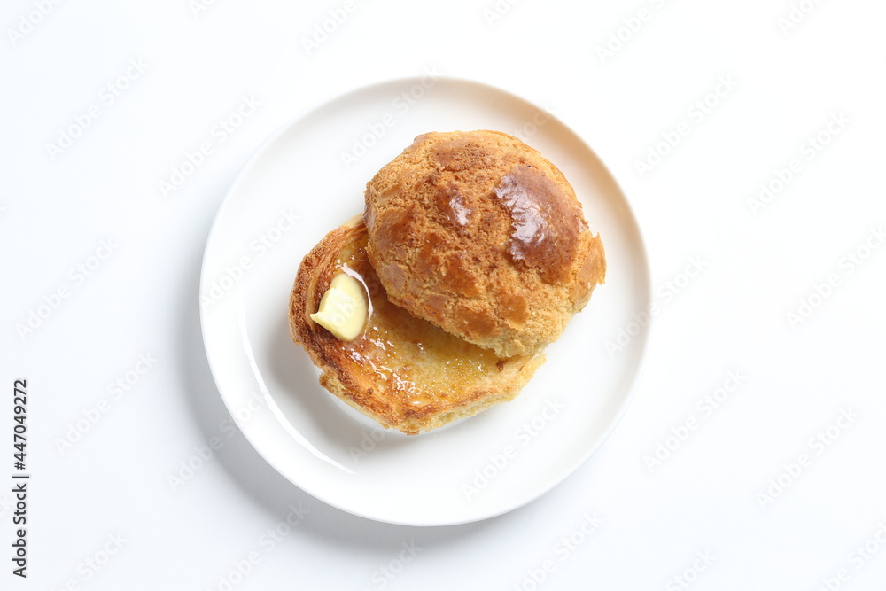 Hong Kong crispy skin polo bun toast with butter and honey jam in white background snack halal menu Hong Kong crispy skin polo bun toast with butter and honey jam in white background snack halal menu