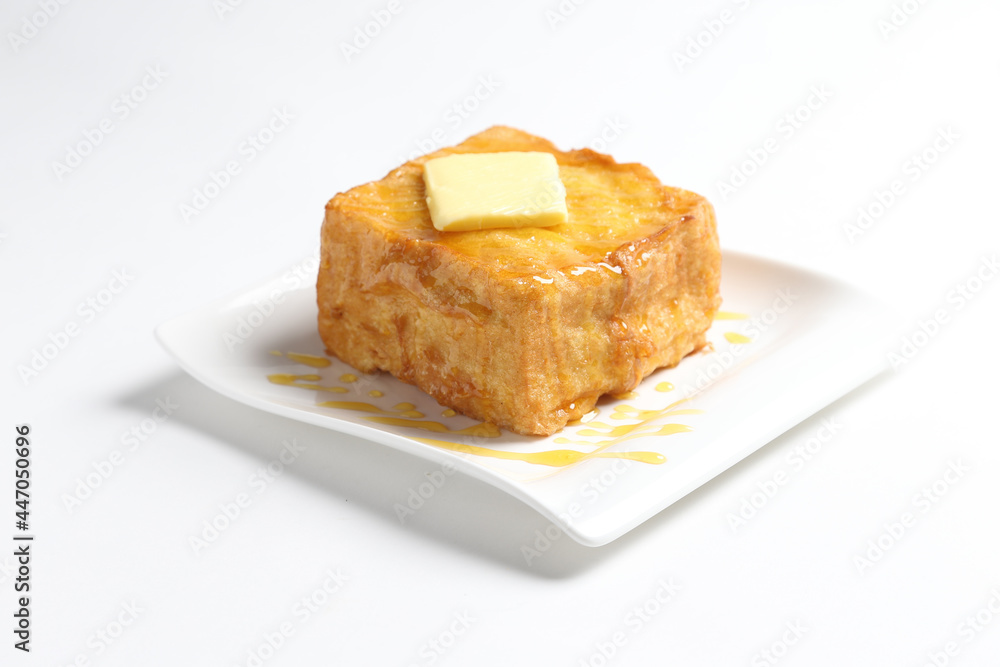 thick egg french toast with butter and honey in white background snack halal menu thick egg french toast with butter and honey in white background snack halal menu